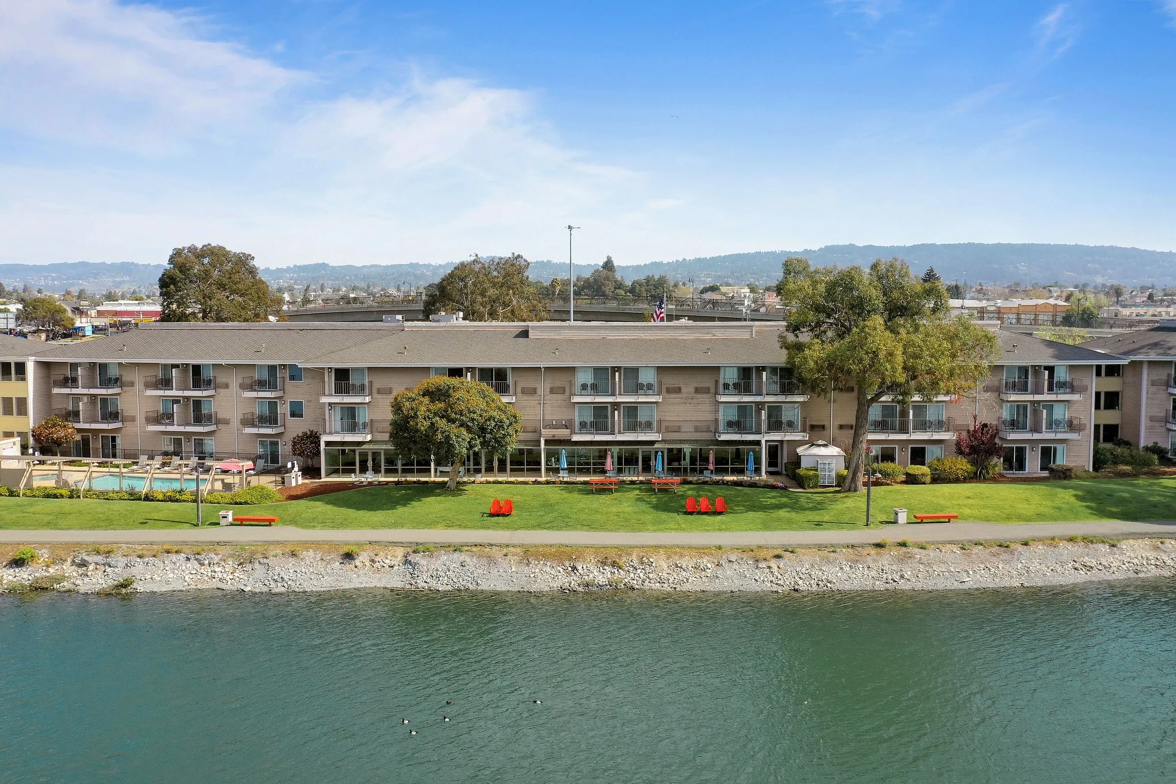 Executive Inn & Suites seen straight across the water of the Oakland estuary on a clear day