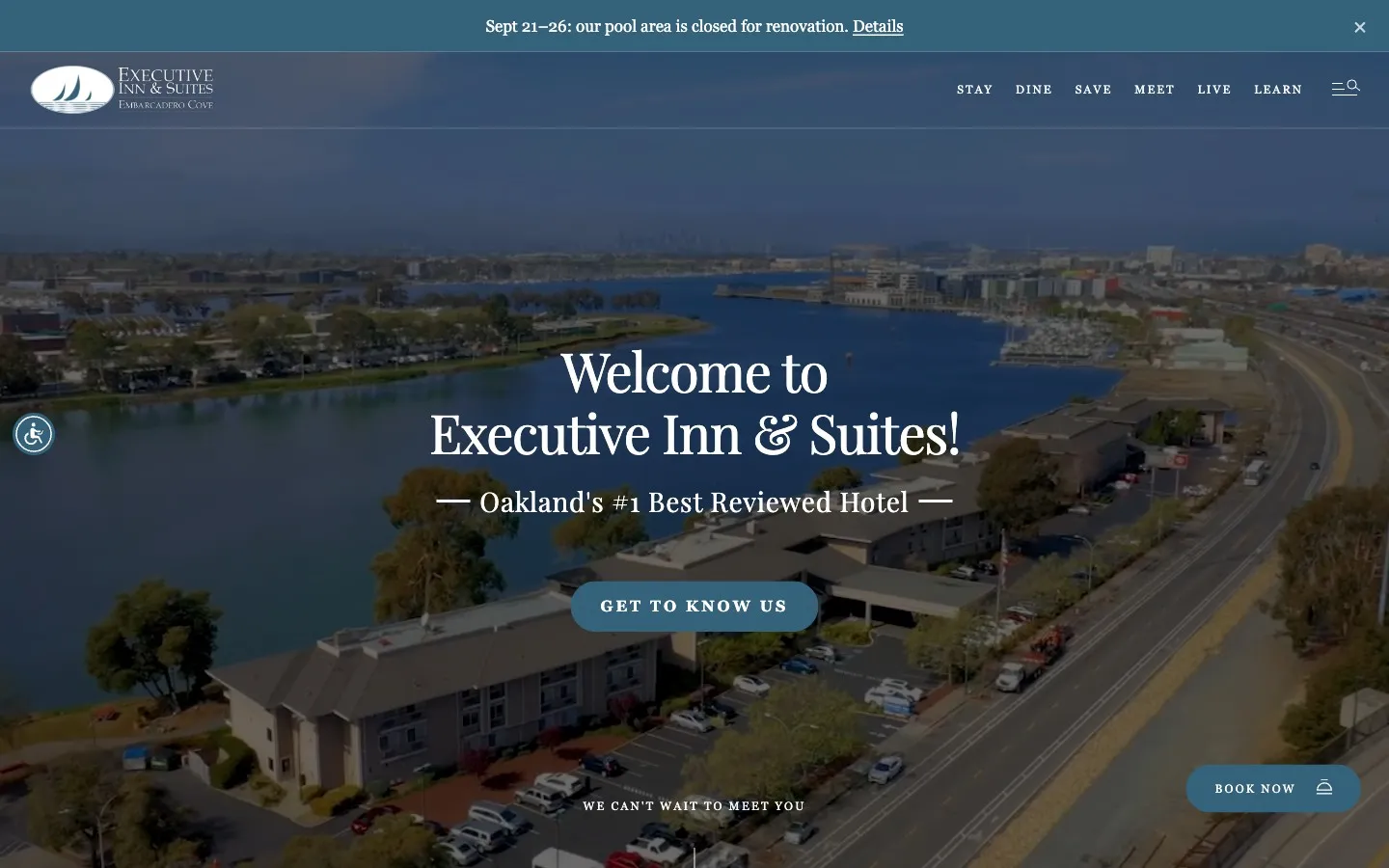 Executive Inn and Suites homepage, an aerial photograph of the hotel on the Oakland estuary under the headline Welcome to Executive Inn and Suites, with a Book now button.