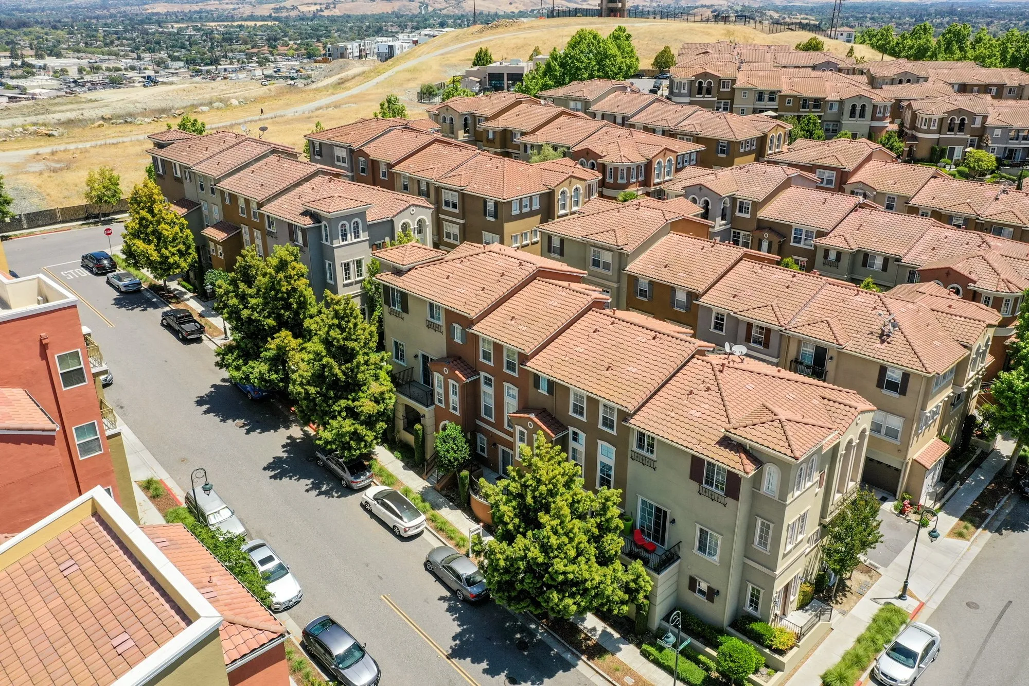Drone photograph of a row of terracotta-roofed townhomes in Livermore on a sunny day